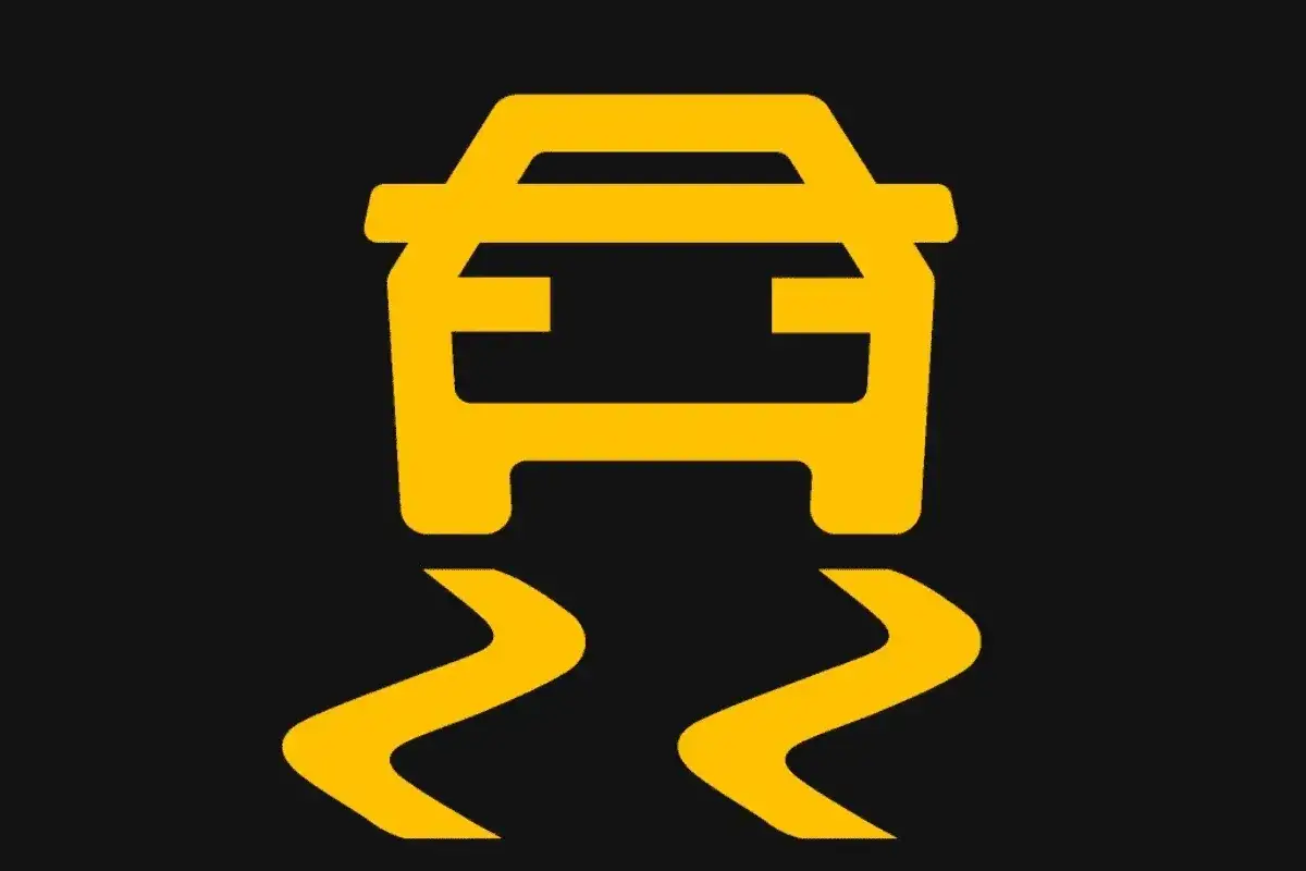 Symbole de voiture jaune sur fond noir, indiquant un problème de traction ou de stabilité.